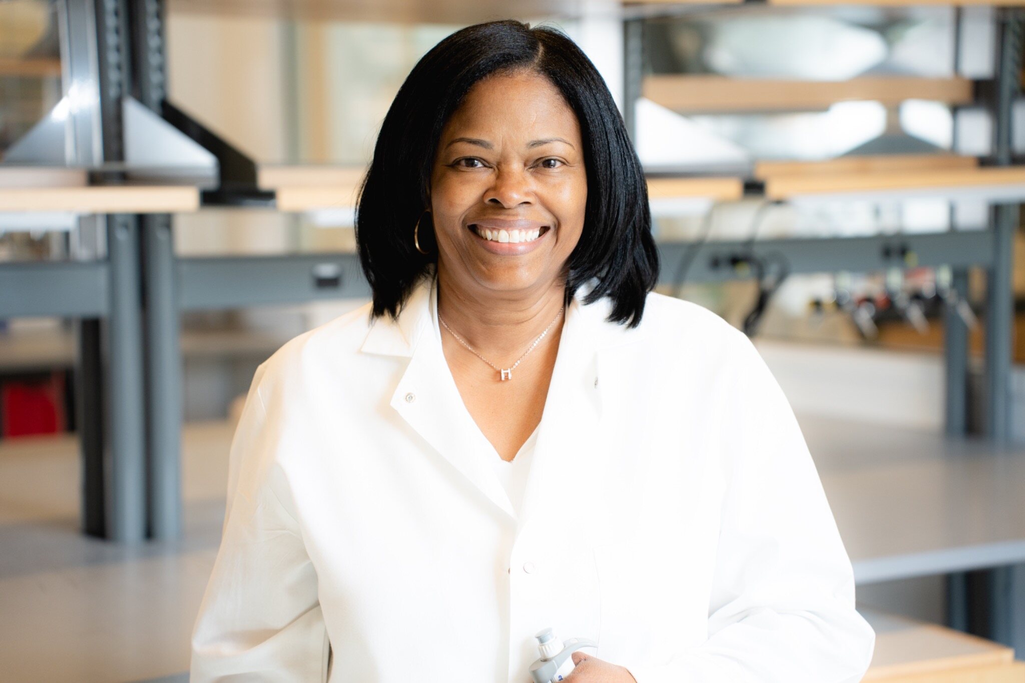 Scientist in a white coat photographed in her laboratory