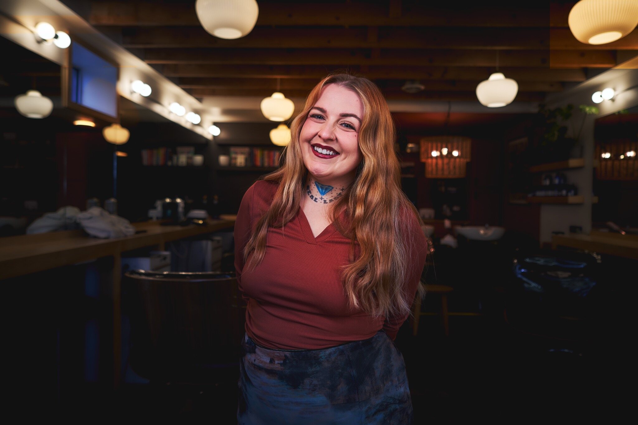 Red-haired woman laughing in a restaurant