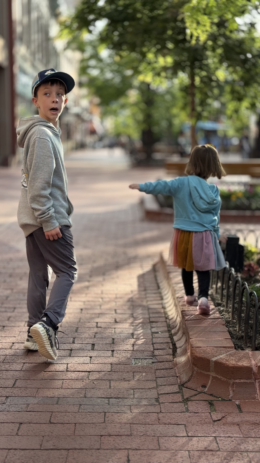 Charlie and Zoe walking together downtown